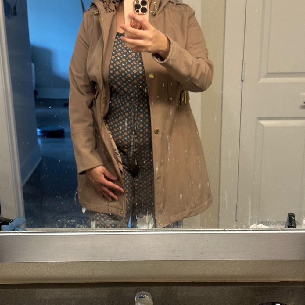 A tan medium jacket, perfect for rain and fall even light winter